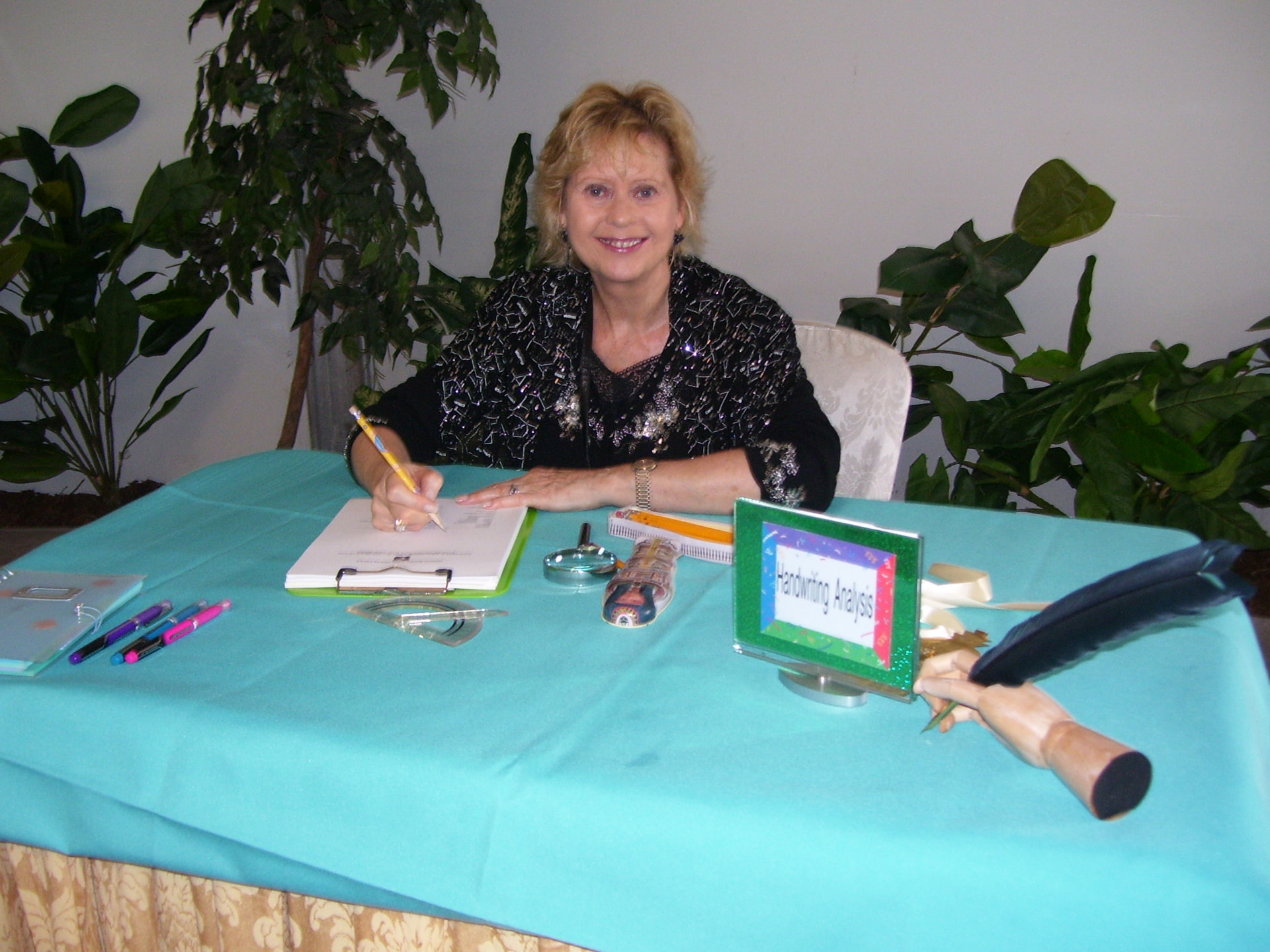 Paula Roberts giving handwriting readings at a 2009 event